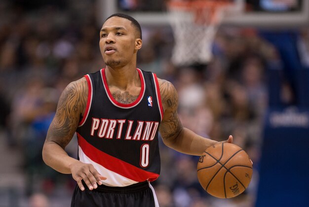 Jan 18, 2014; Dallas, TX, USA; Portland Trail Blazers point guard Damian Lillard (0) brings the ball up court during the game against the Dallas Mavericks at the American Airlines Center. The Trail Blazers defeated the Mavericks 127-111. Mandatory Credit: Jerome Miron-USA TODAY Sports