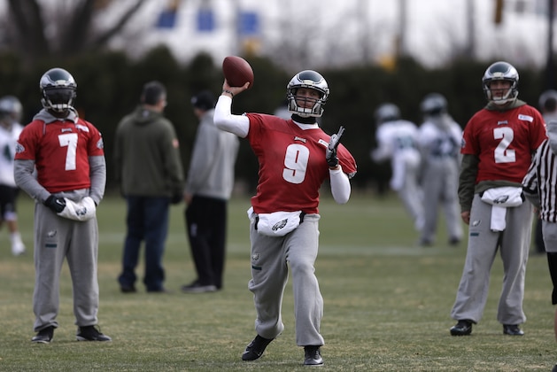 Philadelphia Eagles quarterback Nick Foles, center, passes while quarterbacks Michael Vick, left, and Matt Barkley look on during NFL football practice at the team's training facility, Wednesday, Jan. 1, 2014, in Philadelphia. The Eagles host the New Orleans Saints in a wild-card playoff game on Saturday. (AP Photo/Matt Rourke)