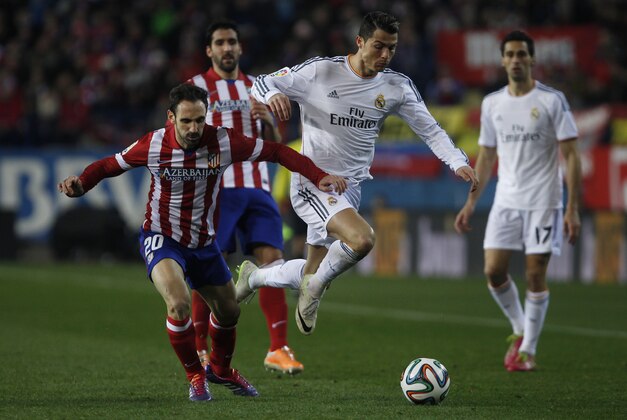 Atletico's Juanfran, left, in action with Real's Cristiano Ronaldo, centre, during a semi final, 2nd leg, Copa del Rey soccer match between Atletico de Madrid and Real Madrid at the Vicente Calderon stadium in Madrid, Spain, Tuesday, Feb. 11, 2014. (AP Photo/Gabriel Pecot) Atletico's Juanfran, left, in action with Real's Cristiano Ronaldo, centre, during a semi final, 2nd leg, Copa del Rey soccer match between Atletico de Madrid and Real Madrid at the Vicente Calderon stadium in Madrid, Spain, Tuesday, Feb. 11, 2014. (AP Photo/Gabriel Pecot)