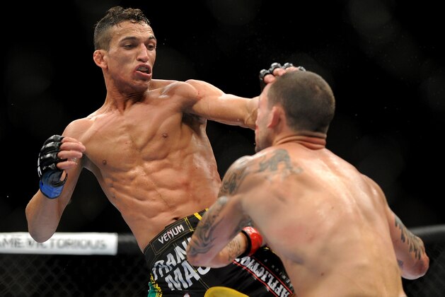 Charles Oliveira, left, and Frankie Edgar battle during their UFC 162 mixed martial arts featherweight bout at the MGM Grand Garden Arena on Saturday, July 6, 2013, in Las Vegas. Edgar won the three round fight with a unanimous decision. (AP Photo/David Becker)