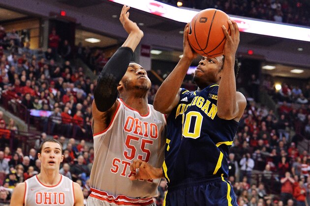 COLUMBUS, OH - FEBRUARY 11:  Derrick Walton Jr. #10 of the Michigan Wolverines drives to the basket and shoots against Trey McDonald #55 of the Ohio State Buckeyes in the first half on February 11, 2014 at Value City Arena in Columbus, Ohio.  (Photo by Jamie Sabau/Getty Images)