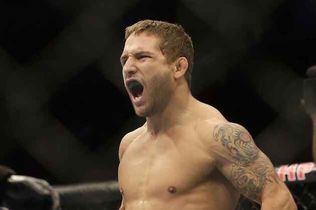 Chad Mendes back flips while celebrating after beating Darren Elkins during the first round of a UFC featherweight mixed martial arts fight in San Jose, Calif., Saturday, April 20, 2013. Mendes won by technical knock out in the first round. (AP Photo/Jeff Chiu)
