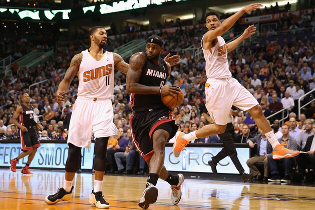 PHOENIX, AZ - FEBRUARY 11:  LeBron James #6 of the Miami Heat drives the ball past Markieff Morris #11 and Gerald Green #14 of the Phoenix Suns during the first half of the NBA game at US Airways Center on February 11, 2014 in Phoenix, Arizona.  NOTE TO USER: User expressly acknowledges and agrees that, by downloading and or using this photograph, User is consenting to the terms and conditions of the Getty Images License Agreement.  (Photo by Christian Petersen/Getty Images)