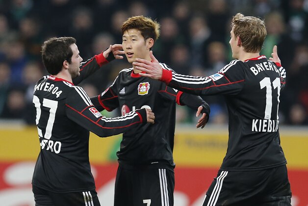 Leverkusen's Son Heung-min Son of South Korea , center, celebrates with Leverkusen's Gonzalo Castro, left, and Leverkusen's Stefan Kiessling after scoring  during the German first division Bundesliga soccer match between Borussia Moenchengladbach and Bayer 04 Leverkusen in Moenchengladbach, Germany, Friday, Feb. 7, 2014. (AP Photo/Frank Augstein)