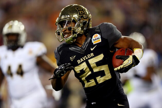 GLENDALE, AZ - JANUARY 01:  Running back Lache Seastrunk #25 of the Baylor Bears carries the ball against the UCF Knights in the first quarter of the Tostitos Fiesta Bowl at University of Phoenix Stadium on January 1, 2014 in Glendale, Arizona.  (Photo by Ronald Martinez/Getty Images)