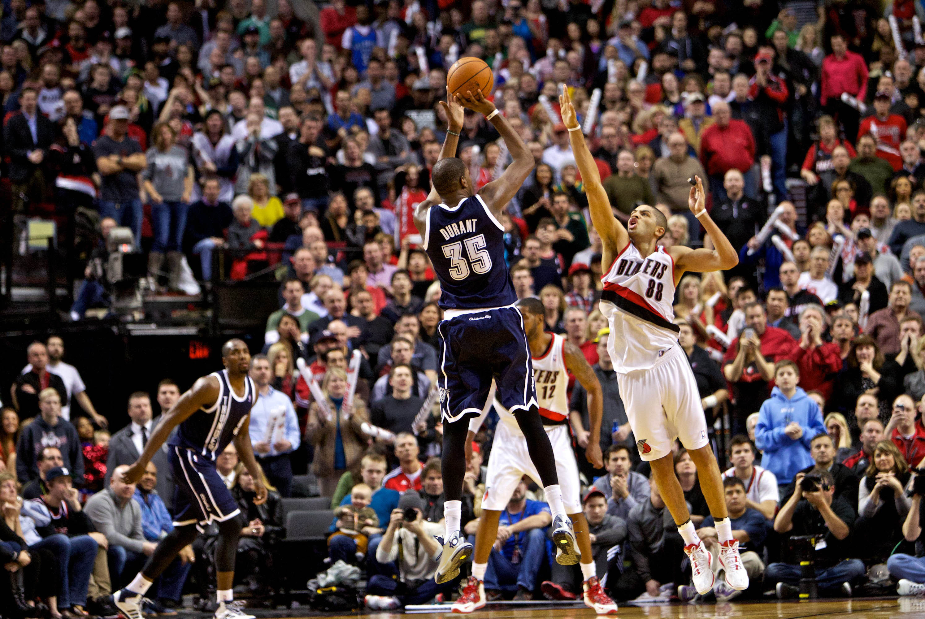 Feb 11, 2014; Portland, OR, USA; Oklahoma City Thunder small forward Kevin Durant (35) shoots over Portland Trail Blazers small forward Nicolas Batum (88) during the fourth quarter at the Moda Center. Mandatory Credit: Craig Mitchelldyer-USA TODAY Sports