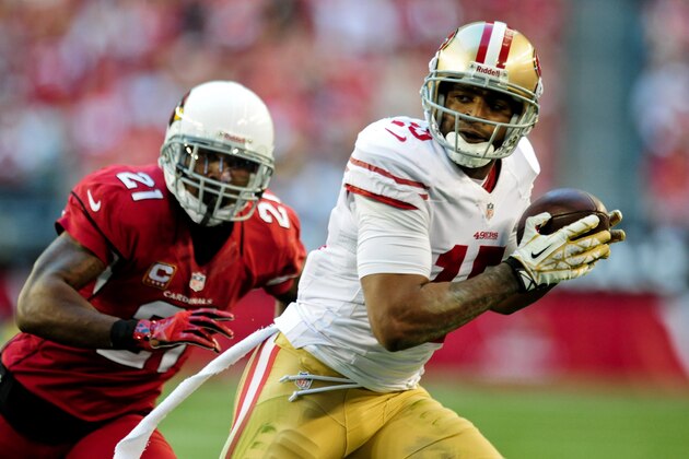 Dec 29, 2013; Phoenix, AZ, USA; San Francisco 49ers wide receiver Michael Crabtree (15) makes a catch as Arizona Cardinals cornerback Patrick Peterson (21) defends during the first half at University of Phoenix Stadium. Mandatory Credit: Matt Kartozian-USA TODAY Sports
