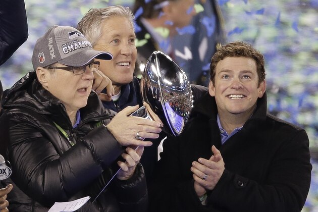 Seattle Seahawks owner Paul Allen, Pete Carroll and General Manager John Schneider, from left, celebrate after the NFL Super Bowl XLVIII football game against the Denver Broncos Sunday, Feb. 2, 2014, in East Rutherford, N.J. The Seahawks won 43-8. (AP Photo/Charlie Riedel)