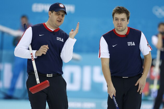 Skip John Shuster of the United States, left, talks shot strategy with teammate Jared Zezel   during men's curling competition against China at the 2014 Winter Olympics, Tuesday, Feb. 11, 2014, in Sochi, Russia. (AP Photo/Robert F. Bukaty)