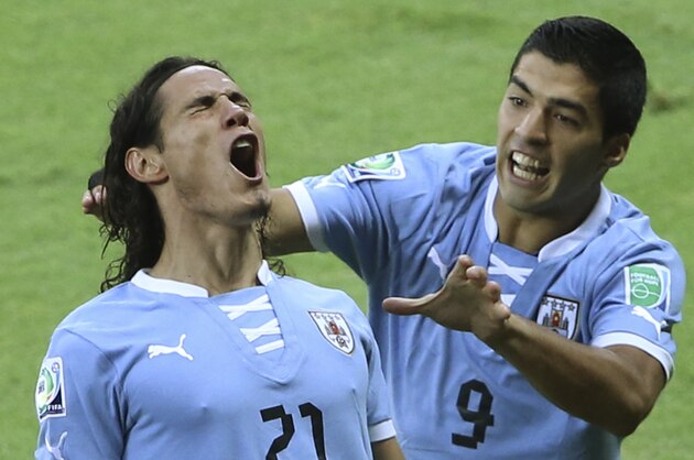 Uruguay's Edinson Cavani, left, is congratulated by his teammate Luis Suarez after scoring his side's first goal during the soccer Confederations Cup semifinal match between Brazil and Uruguay at the Mineirao stadium in Belo Horizonte, Brazil, Wednesday, June 26, 2013. (AP Photo/Andre Penner)