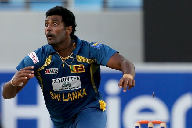 DUBAI, UNITED ARAB EMIRATES - DECEMBER 20:  Thisara Perera of Sri Lanka bowls during the second One-Day International (ODI ) match between Sri Lanka and Pakistan at the Dubai Sports City Cricket Stadium on December 20, 2013 in Dubai, United Arab Emirates.  (Photo by Francois Nel/Getty Images)