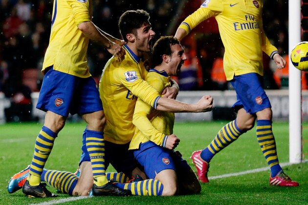 Arsenal's Santi Cazorla, center right, celebrates his goal with teammate Olivier Giroud, center left, during the English Premier League soccer match between Southampton and Arsenal at St Mary's stadium in Southampton, England, Tuesday, Jan. 28, 2014. (AP Photo/Matt Dunham) Arsenal's Santi Cazorla, center right, celebrates his goal with teammate Olivier Giroud, center left, during the English Premier League soccer match between Southampton and Arsenal at St Mary's stadium in Southampton, England, Tuesday, Jan. 28, 2014. (AP Photo/Matt Dunham)