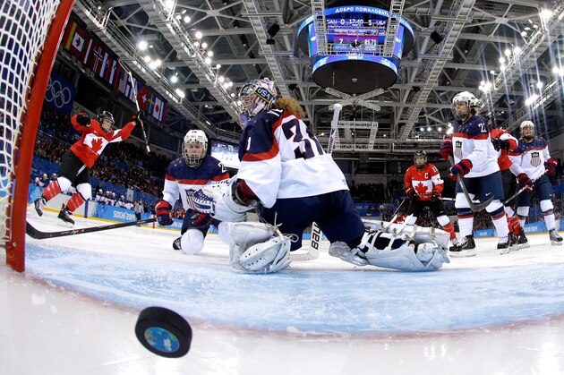 SOCHI, RUSSIA - FEBRUARY 12:  Meghan Agosta-Marciano #2 of Canada celebrates scoring a goal in the third period against Jessie Vetter #31 of the United States during the Women's Ice Hockey Preliminary Round Group A game on day five of the Sochi 2014 Winter Olympics at Shayba Arena on February 12, 2014 in Sochi, Russia.  (Photo by Pool/Getty Images)