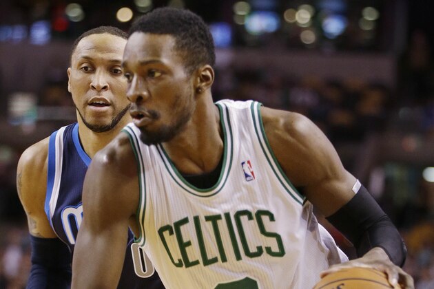 Boston Celtics small forward Jeff Green (8) drives the baseline past Dallas Mavericks small forward Shawn Marion (0) during the first half of their NBA basketball game in Boston, Sunday, Feb. 9, 2014. (AP Photo/Stephan Savoia)