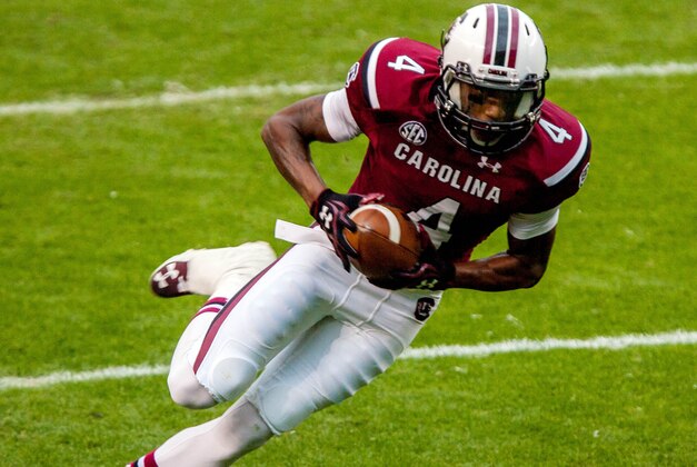 Nov 23, 2013; Columbia, SC, USA; South Carolina Gamecocks wide receiver Shaq Roland (4) makes a touchdown reception against the Coastal Carolina Chanticleers in the first half at Williams-Brice Stadium. Mandatory Credit: Jeff Blake-USA TODAY