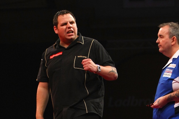 LONDON, ENGLAND - JANUARY 01:   Adrian Lewis of England (L) celebrates a point in his game against Phil Taylor of England during the Quarter Finals of the 2010 Ladbrokes.com World Darts Championships at Alexandra Palace on January 1, 2010 in London, England.  (Photo by John Gichigi/Getty Images)