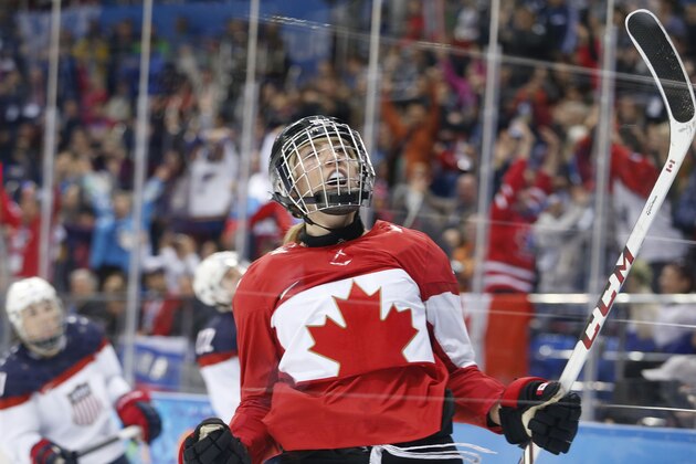 Meghan Agosta-Marciano of Canada celebrates her second goal against the United States during the 2014 Winter Olympics women's ice hockey game at Shayba Arena, Wednesday, Feb. 12, 2014, in Sochi, Russia. (AP Photo/Julio Cortez)
