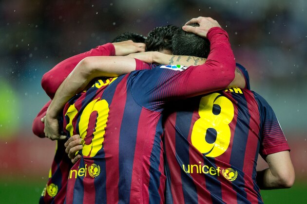 SEVILLE, SPAIN - FEBRUARY 09:  Lionel Messi of FC Barcelona celebrates scoring their third goal with teammates during the La Liga match between Sevilla FC and FC Barcelona at Estadio Ramon Sanchez Pizjuan on February 9, 2014 in Seville, Spain.  (Photo by Gonzalo Arroyo Moreno/Getty Images)