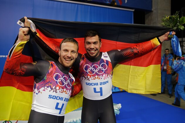 SOCHI, RUSSIA - FEBRUARY 12:  Tobias Wendl (R) and Tobias Arlt of Germany celebrate during the flower ceremony after winning the gold medal during the Men's Luge Doubles on Day 5 of the Sochi 2014 Winter Olympics at Sliding Center Sanki on February 12, 2014 in Sochi, Russia.  (Photo by Ezra Shaw/Getty Images)