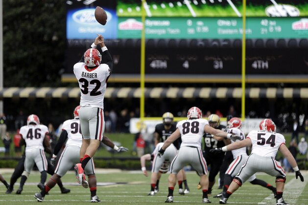 Georgia punter Collin Barber (32) fumbles the snap on a punt attempt against Vanderbilt late in the fourth quarter of an NCAA college football game on Saturday, Oct. 19, 2013, in Nashville, Tenn. Barber recovered the ball on the play and Vanderbilt took possession on the 13-yard line and scored the game-winning touchdown on the next play. Vanderbilt upset No. 15 Georgia 31-27. (AP Photo/Mark Humphrey)