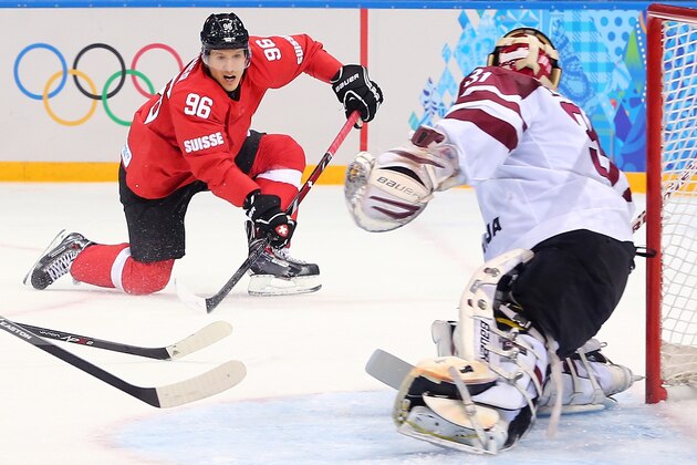 SOCHI, RUSSIA - FEBRUARY 12: Damien Brunner #96 of Switzerland shoots against Edgars Masalskis #31 of Latvia in the first period during the Men's Ice Hockey Preliminary Round Group C game on day five of the Sochi 2014 Winter Olympics at Shayba Arena on February 12, 2014 in Sochi, Russia.  (Photo by Martin Rose/Getty Images)