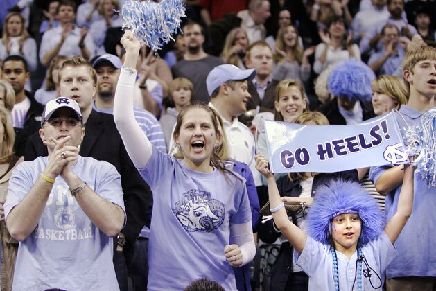 ** FILE ** This is a March 29, 2008 file photo showing North Carolina fans cheering during the NCAA East Regional final basketball game against Louisville, in Charlotte, N.C. Duke only has to travel an hour from campus for the first weekend of the NCAA tournament, but the Blue Devils don't expect much of a home-court advantage. Rival North Carolina also is setting up shop in Greensboro, and the Tar Heels are expected to turn the Greensboro Coliseum into Dean Dome West, packing it with thousands of baby blue-clad fans who love nothing more than hating Duke. (AP Photo/Chuck Burton, File)