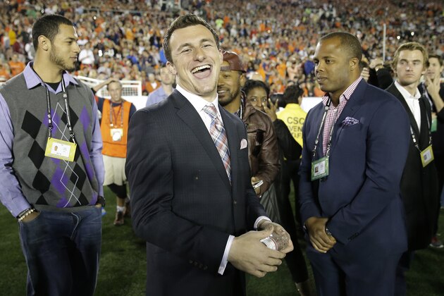 Texas A&M quarterback Johnny Manziel smiles from the sidelines during the first half of the NCAA BCS National Championship college football game between Auburn and Florida State Monday, Jan. 6, 2014, in Pasadena, Calif. (AP Photo/David J. Phillip)