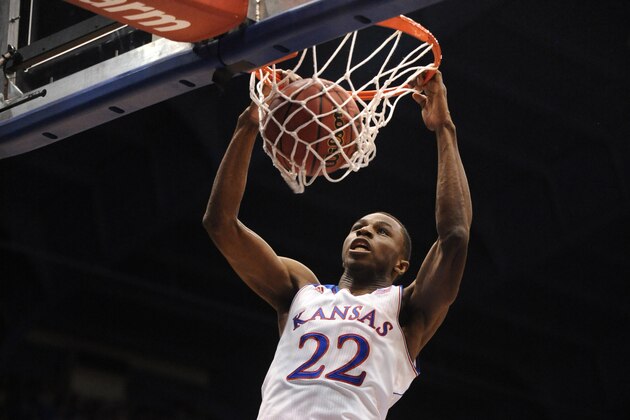 Nov 22, 2013; Lawrence, KS, USA; Kansas Jayhawks guard Andrew Wiggins (22) dunks the ball as Towson Tigers forward John Davis (10) defends during the first half of the game at Allen Fieldhouse. Mandatory Credit: Denny Medley-USA TODAY Sports