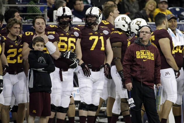 Minnesota coach Jerry Kill, right, looks at the scoreboard during the second half of the Texas Bowl NCAA college football game against Syracuse, Friday, Dec. 27, 2013, in Houston. Syracuse won 21-17. (AP Photo/David J. Phillip)