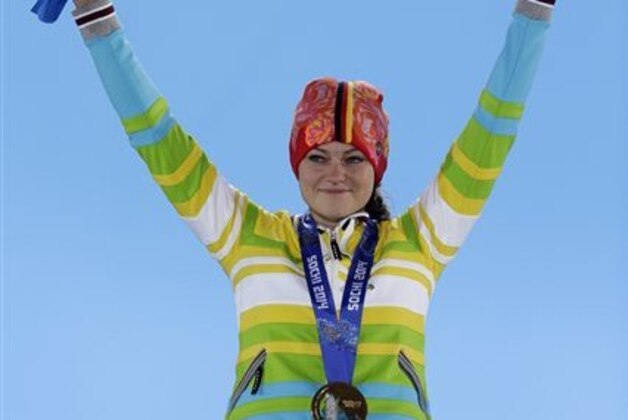 Women's normal hill ski jumping gold medalist Carina Vogt of Germany gestures on the podium during the medals ceremony at the 2014 Winter Olympics, Wednesday, Feb. 12, 2014, in Sochi, Russia. (AP Photo/Morry Gash)