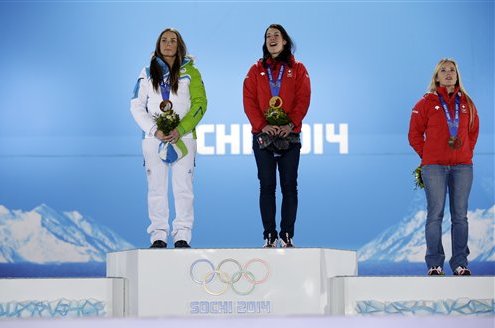 Women's downhill medalists, from left, Slovenia's Tina Maze and Switzerland's Dominique Gisin, who tied for the gold, and Switzerland's Lara Gut, who finished third for the bronze, pose with their medals at the 2014 Winter Olympics in Sochi, Russia, Wednesday, Feb. 12, 2014. (AP Photo/Morry Gash)