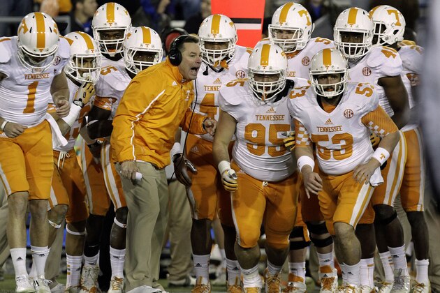 Tennessee coach Butch Jones, center, sends his team ontp the field in the fourth quarter against Kentucky in an NCAA college football game in Lexington, Ky., Saturday, Nov. 30, 2013. Tennessee won 27-14. (AP Photo/Garry Jones)