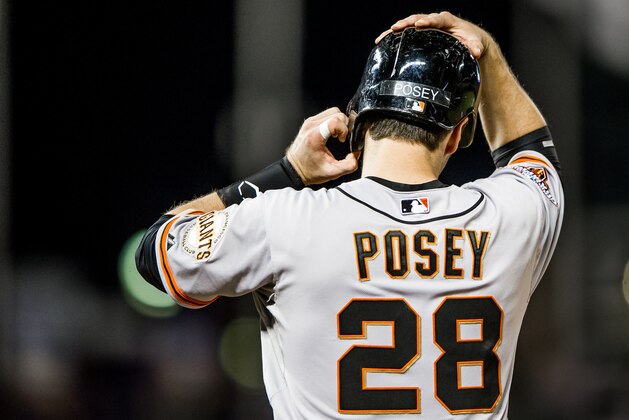 DENVER, CO - AUGUST 26: Buster Posey #28 of the San Francisco Giants stands at first base after hitting a single against the Colorado Rockies at Coors Field on August 26, 2013 in Denver, Colorado. The Rockies beat the Giants 6-1. (Photo by Dustin Bradford/Getty Images)