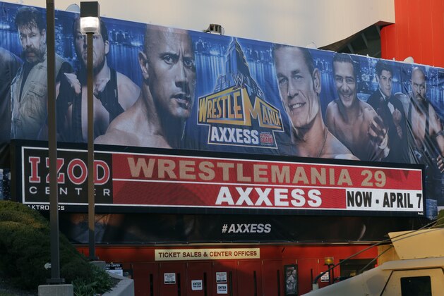 A sign on the IZOD Center outside the Wrestlemania Axxess event Saturday, April 6, 2013, in East Rutherford, N.J., ahead of Sunday's WWE Wrestlemania 29 wrestling event at MetLife stadium. (AP Photo/Mel Evans)