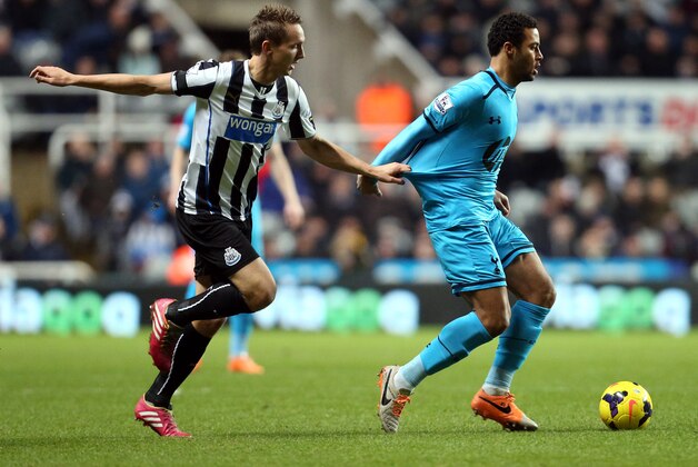 Newcastle United's Luuk De Jong, left, vies for the ball with  Tottenham Hotspur's Moussa Dembele, right, during their English Premier League soccer match at St James' Park, Newcastle, England, Wednesday, Feb. 12, 2014. (AP Photo/Scott Heppell)