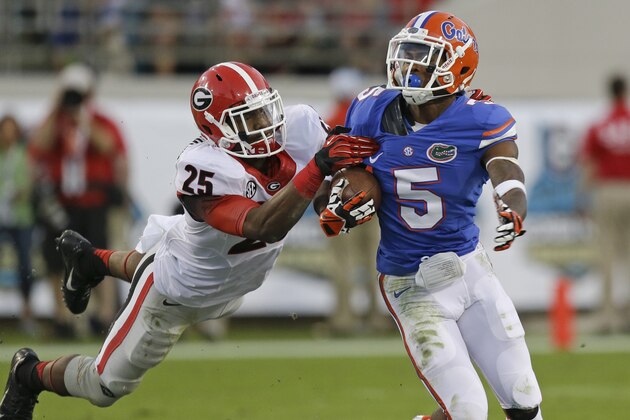 Georgia safety Josh Harvey-Clemons (25) brings down Florida's Ahmad Fulwood (5)during a punt return in the second half of an NCAA college football game in Jacksonville, Fla., Saturday, Nov. 2, 2013.Georgia won the game 23-20. (AP Photo/John Raoux)