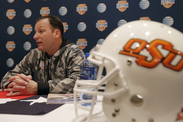 Oklahoma State Offensive Coordinator Mike Yurcich speaks to the media during an NCAA college football press conference, Wednesday, Jan. 1, 2014, in Irving, Texas. Oklahoma State takes on Missouri in the Cotton Bowl on Friday in Arlington, Texas. (AP Photo/Brandon Wade)