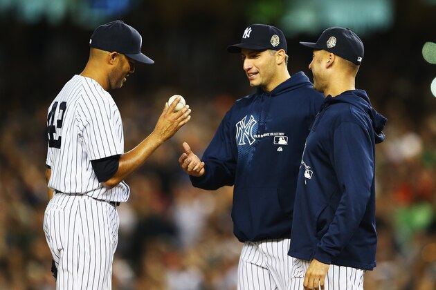 NEW YORK, NY - SEPTEMBER 26:  Mariano Rivera #42 of the New York Yankees is taken out of the game by Derek Jeter #2, and Andy Pettitte #46 in the ninth inning against the Tampa Bay Rays during their game on September 26, 2013 at Yankee Stadium in the Bronx borough of New York City.  (Photo by Al Bello/Getty Images)