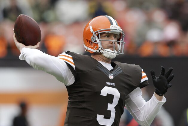 Cleveland Browns quarterback Brandon Weeden passes to wide receiver Josh Gordon for a first down against the Jacksonville Jaguars in the first quarter of an NFL football game on Sunday, Dec. 1, 2013, in Cleveland. (AP Photo/Tony Dejak)