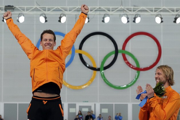 Bronze medallist Michel Mulder from the Netherlands, right, applauds country skater and gold medallist Stefan Groothuis during the flower ceremony for the men's 1000-meter speedskating race at the Adler Arena Skating Center during the 2014 Winter Olympics in Sochi, Russia, Wednesday, Feb. 12, 2014. (AP Photo/Matt Dunham) Bronze medallist Michel Mulder from the Netherlands, right, applauds country skater and gold medallist Stefan Groothuis during the flower ceremony for the men's 1000-meter speedskating race at the Adler Arena Skating Center during the 2014 Winter Olympics in Sochi, Russia, Wednesday, Feb. 12, 2014. (AP Photo/Matt Dunham)
