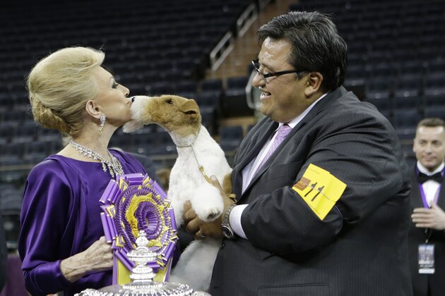 Judge Betty Regina Leininger, left, and handler Gabriel Rangel, pose with Sky, a wire fox terrier, after winning best in show at the Westminster Kennel Club dog show, Tuesday, Feb. 11, 2014, in New York. (AP Photo/Frank Franklin II)