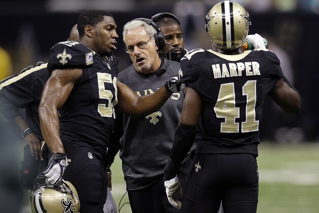 New Orleans Saints acting head coach Joe Vitt, center, talks with outside linebacker Jonathan Vilma (51) and strong safety Roman Harper (41) in the first half an NFL football game against the Atlanta Falcons at the Mercedes-Benz Superdome in New Orleans, Sunday, Nov. 11, 2012. (AP Photo/Bill Haber)