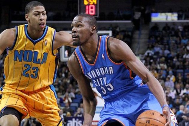 Oklahoma City Kevin Durant (35) drives against New Orleans Anthony Davis (23) during the first half of an NBA basketball game in New Orleans, Friday, Nov. 16, 2012. (AP Photo/Jonathan Bachman)