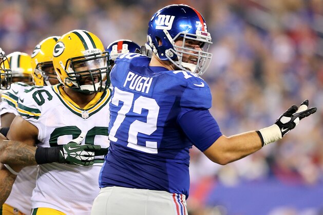 EAST RUTHERFORD, NJ - NOVEMBER 17: Mike Neal #96 of the Green Bay Packers and Justin Pugh #72 of the New York Giants exchange words in the second half at MetLife Stadium on November 17, 2013 in East Rutherford, New Jersey.The New York Giants defeated the Green Bay Packers 27-13. (Photo by Elsa/Getty Images) EAST RUTHERFORD, NJ - NOVEMBER 17: Mike Neal #96 of the Green Bay Packers and Justin Pugh #72 of the New York Giants exchange words in the second half at MetLife Stadium on November 17, 2013 in East Rutherford, New Jersey.The New York Giants defeated the Green Bay Packers 27-13. (Photo by Elsa/Getty Images)