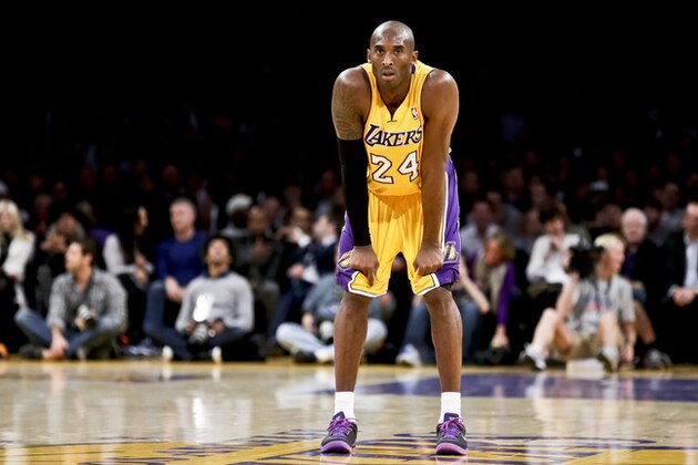 Los Angeles Lakers guard Kobe Bryant watches his team during an NBA basketball game against the Phoenix Suns in Los Angeles, Tuesday, Dec. 10, 2013. (AP Photo/Chris Carlson)