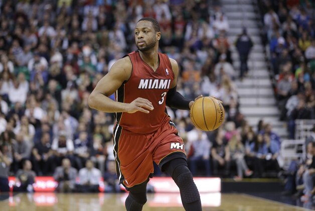 Miami Heat's Dwyane Wade (3) brings the ball up court in the second half of an NBA basketball game against the Utah Jazz Saturday, Feb. 8, 2014, in Salt Lake City. (AP Photo/Rick Bowmer)