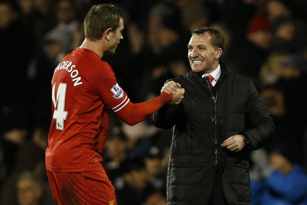 Liverpool's manager Brendan Rodgers, right, and Jordan Henderson celebrate their win against Fulham at the end of their English Premier League soccer match at Craven Cottage, London, Wednesday, Feb. 12, 2014. (AP Photo/Sang Tan)