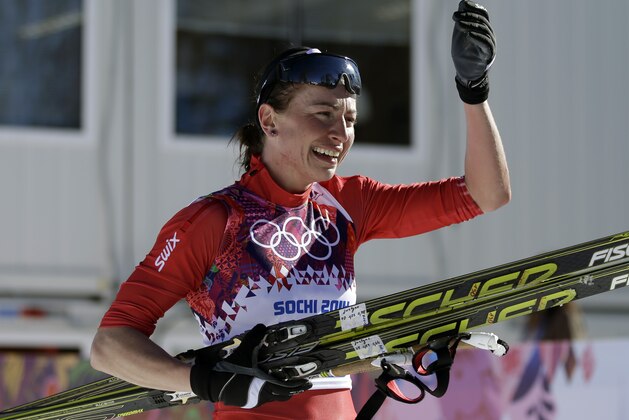 Poland's Justyna Kowalczyk celebrates  after winning the women's 10K classical-style cross-country race at the 2014 Winter Olympics, Thursday, Feb. 13, 2014, in Krasnaya Polyana, Russia. (AP Photo/Gregorio Borgia)