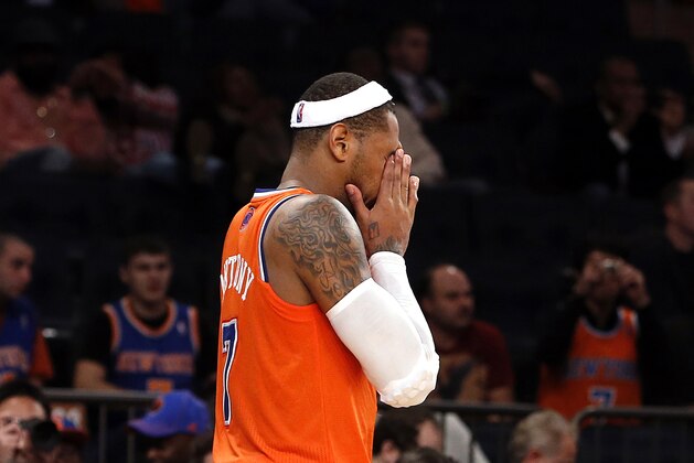 New York Knicks' Carmelo Anthony (7) walks off the court at the end of regulation during the second half of an NBA basketball game against the Atlanta Hawks Saturday, Nov. 16, 2013, in New York.  Atlanta defeated New York 110-90. (AP Photo/Jason DeCrow)