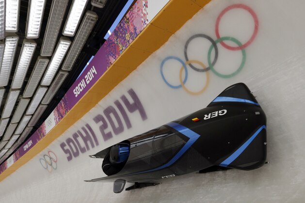 The GER-3 sled from Germany takes a turn during a training run for the two-man bobsled at the 2014 Winter Olympics, Thursday, Feb. 6, 2014, in Krasnaya Polyana, Russia. (AP Photo/Michael Sohn)